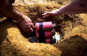 During a training session focused on neutralizing explosive weapons that would be found on a battlefield, members of the Explosive Ordnance Disposal team at Joint Base McGuire-Dix-Lakehurst lay thermite devices on a simulated land mine.